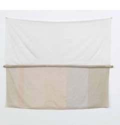 An artwork hanging on a wall, composed of a piece of white fabric on top and a striped beige fabric on the bottom, with a horizontal fabric-wrapped pole in the center.
