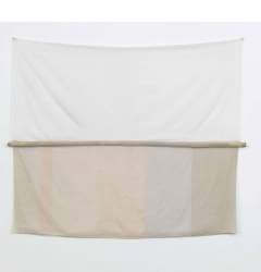An artwork hanging on a wall, composed of a piece of white fabric on top and a striped beige fabric on the bottom, with a horizontal fabric-wrapped pole in the center.