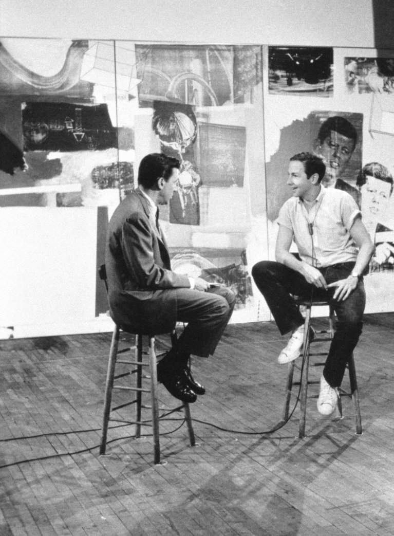 Rauschenberg interviewed by TV anchor Mike Wallace for the CBS television program Eye on New York. New York, May 1964. Work in background is Axle (1964). Photo: CBS/Landov