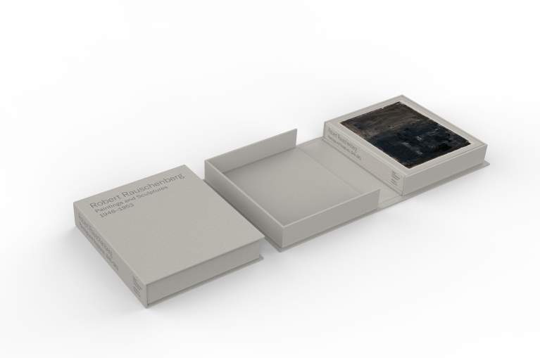 A gray hardcover bound book and case depicting a black painting by Robert Rauschenberg.