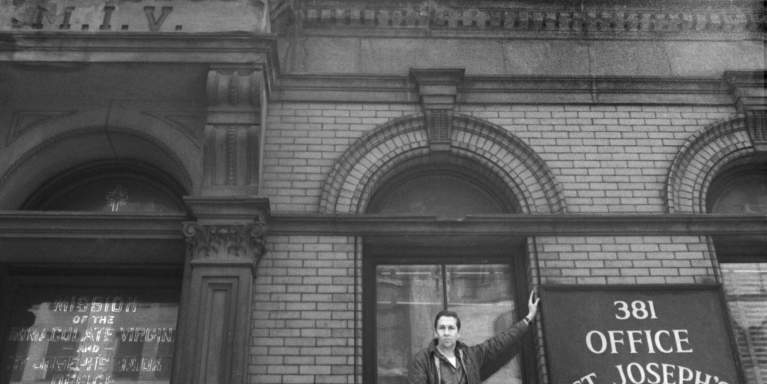 man standing in front of building