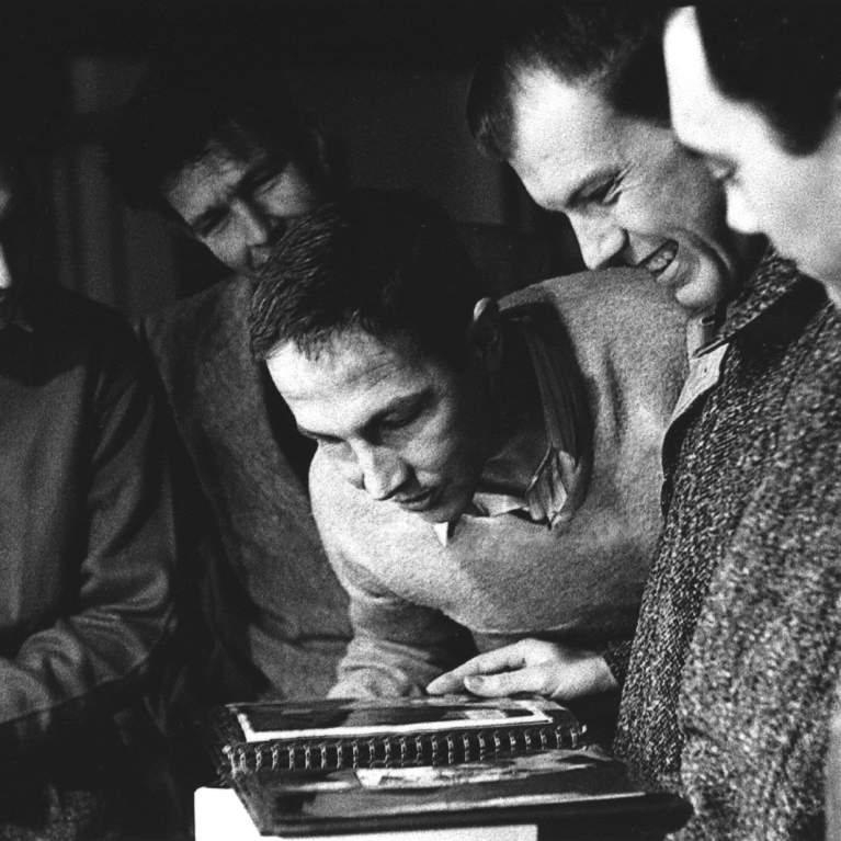 group of people looking at book