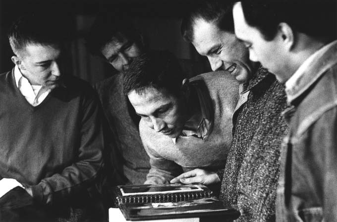 group of people looking at book